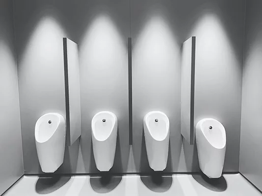 Four urinals in a bathroom